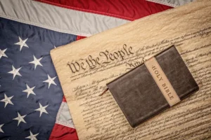 Holy Bible on constitution and American Flag By cherylvb/stock.adobe.com