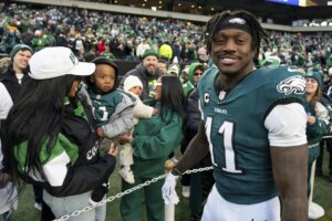 Philadelphia Eagle wide receiver A.J. Brown (11) looks on after talking with his son before an NFL wild-card playoff football game against the Green Bay Packers, Sunday, Jan. 12, 2025, in Philadelphia. (AP Photo/Chris Szagola)