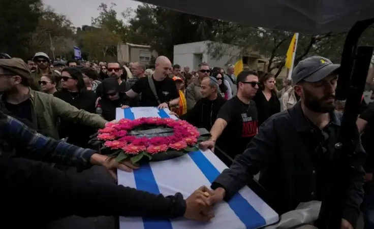 Mourners carry the coffin of Itzhak Elgarat, a slain hostage who was held captive by Hamas in Gaza, during his funeral procession in Kibbutz Nir Oz, Israel, on Monday, March 3, 2025. (AP Photo/Ohad Zwigenberg)