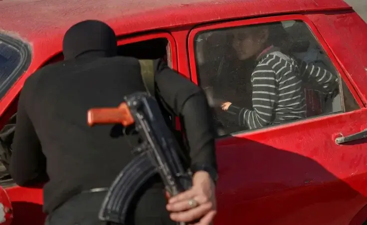 Syrian security forces inspect vehicles at a checkpoint, following a recent wave of violence between Syrian security forces and gunmen loyal to former President Bashar Assad, as well as subsequent sectarian attacks, in Latakia, in Syria's coastal region, Tuesday, March 11, 2025. (AP Photo/Ghaith Alsayed)