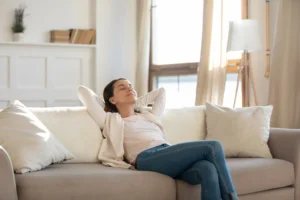 Woman relaxing in her home. By By fizkes/stock.adobe.com. Wellness rooms, panic rooms