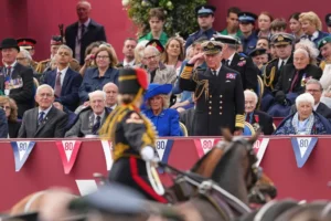Britain's King Charles III salutes as he watches the VE Day 80th anniversary parade in London, Monday, May 5, 2025. (AP Photo/Frank Augstein)