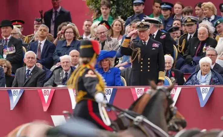 Britain's King Charles III salutes as he watches the VE Day 80th anniversary parade in London, Monday, May 5, 2025. (AP Photo/Frank Augstein)