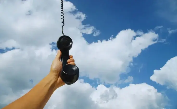 Vintage phone descending from the sky to a person's hand. By By tarapatta/stock.adobe.com. National Day of Prayer, hearing God's voice