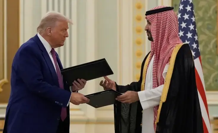 President Donald Trump and Saudi Crown Prince Mohammed bin Salman exchange documents during a signing ceremony at the Royal Palace, Tuesday, May 13, 2025. (AP Photo/Alex Brandon) Trump Middle East
