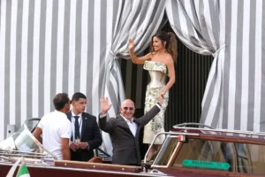 Jeff Bezos, center left, and Lauren Sanchez, center right, leave a hotel for their pre wedding reception, in Venice, Italy, Thursday, June 26, 2025. (AP Photo/Luca Bruno)