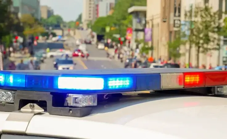 A police car rushes to the emergency call with lights turned on. By christian/stock.adobe.com