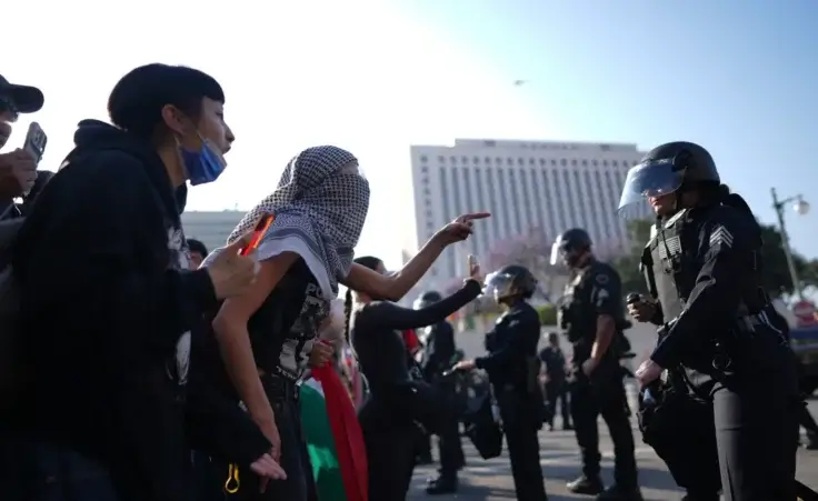 Protesters confront Los Angeles police department personnel in riot gear in downtown Los Angeles on Monday, June 9, 2025. (AP Photo/Eric Thayer)
