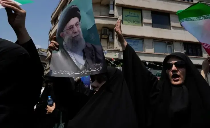 Iranian protesters chant slogans as one of them holds up a poster of the Supreme Leader Ayatollah Ali Khamenei in an anti-Israeli gathering in Tehran, Iran, Friday, June 13, 2025. (AP Photo/Vahid Salemi)