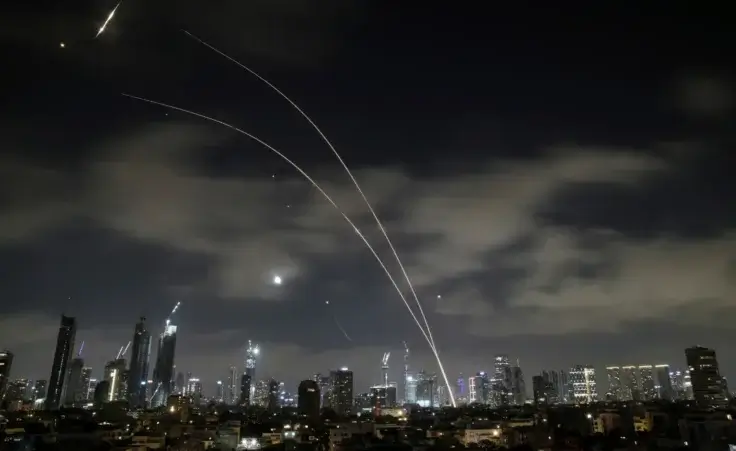 Israeli air defense system fires to intercept missiles during an Iranian attack over Tel Aviv, Israel, early Wednesday, June 18, 2025. (AP Photo/Leo Correa)