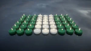 Candles with the colors of the Nigerian flag. In memory of the victims. By Negro Elkha/stock.adobe.com