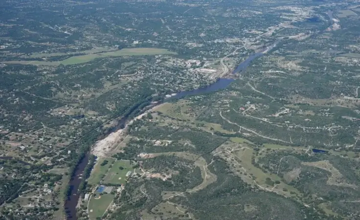 Water runs through the Guadalupe River on Tuesday, July 8, 2025, near Kerrville, Texas, after a flash flood swept through the area. (AP Photo/Ashley Landis) texas flood