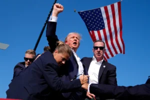 Republican presidential candidate former President Donald Trump is surrounded by U.S. Secret Service agents after an assassination attempt at a campaign rally in Butler, Pa., Saturday, July 13, 2024. Months before the assassination attempt, some Pennsylvania lawmakers had proposed to outlaw the type of rifle used in the shooting. (AP Photo/Evan Vucci, File)