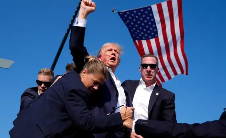 Republican presidential candidate former President Donald Trump is surrounded by U.S. Secret Service agents after an assassination attempt at a campaign rally in Butler, Pa., Saturday, July 13, 2024. Months before the assassination attempt, some Pennsylvania lawmakers had proposed to outlaw the type of rifle used in the shooting. (AP Photo/Evan Vucci, File)