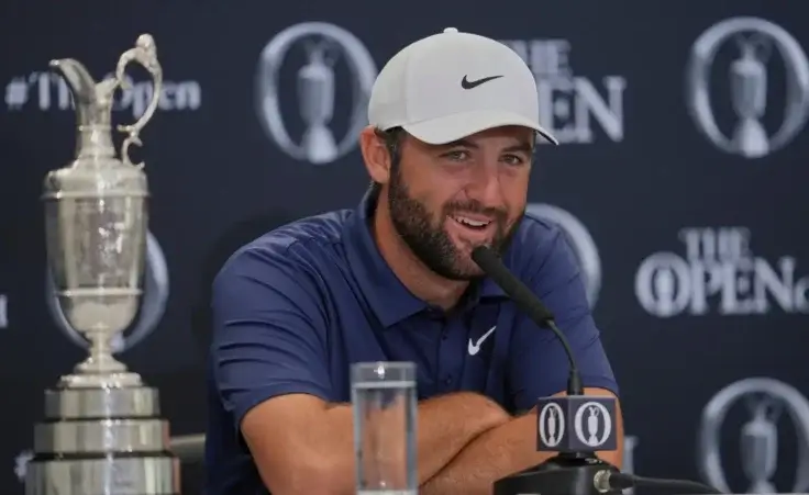Scottie Scheffler of the United States speak at a press conference after winning the British Open golf championship at the Royal Portrush Golf Club, Northern Ireland, Sunday, July 20, 2025. (AP Photo/Jon Super)