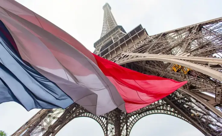 Eiffel Tower and French Flag. By SavvapanfPhoto©/stock.adobe.com. Emmanuel Macron Brigitte Macron