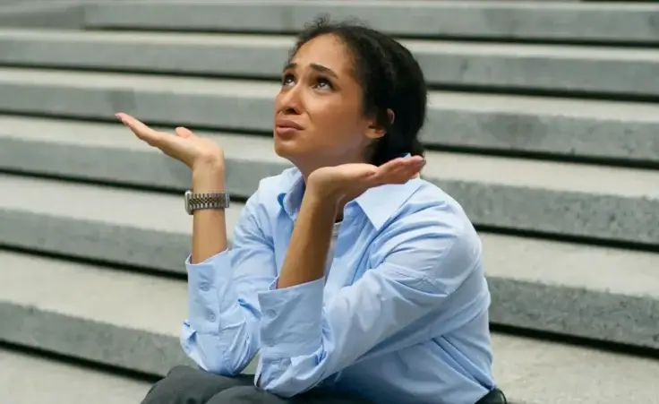 Depressed stressed African American businesswoman talking to God heaven upset business woman girl female employer suffering failure job lost in city sit on stairs headache unemployment crisis problem By Yuliia/stock.adobe.com
