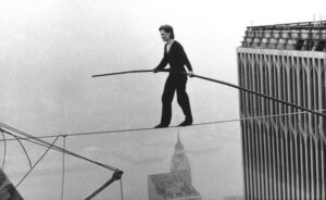 In this Aug. 7, 1974, file photo, Philippe Petit, a French high wire artist, walks across a tightrope suspended between the World Trade Center's Twin Towers in New York. Petit and his companions surreptitiously strung a wire between New York City's recently constructed World Trade Towers on Aug. 6, 1974, and Petit walked across it the next day. He danced, strutted and clowned around for 45 minutes as startled bystanders watched from 110 stories below. The Frenchman's stunt is the subject of the 2008 documentary "Man on Wire" and the 2015 film "The Walk," starring Joseph Gordon-Levitt. (AP Photo/Alan Welner, File)