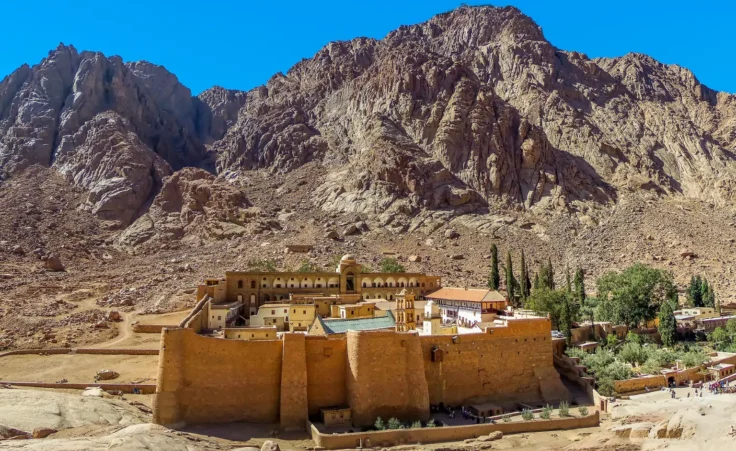 A summertime view of Mount Sinai with Saint Catherine's Monastery at the foot of the mountain in Egypt. By Nicola/stock.adobe.com