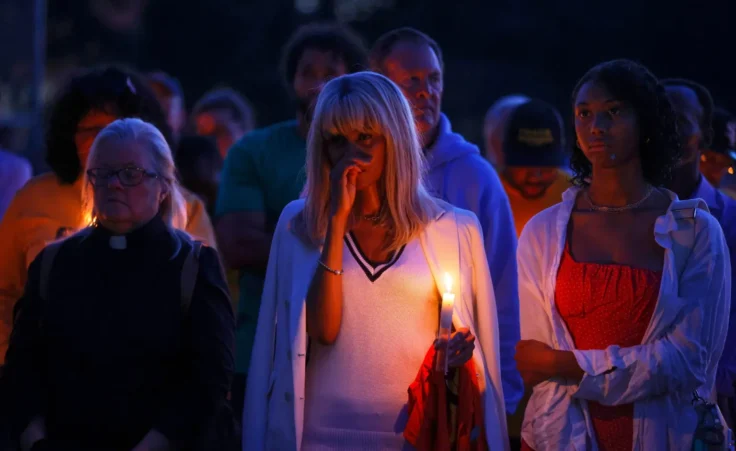 People gather at a vigil at Lynnhurst Park after a shooting at the Annunciation Catholic School Wednesday, Aug. 27, 2025, in Minneapolis. (AP Photo/Bruce Kluckhohn)