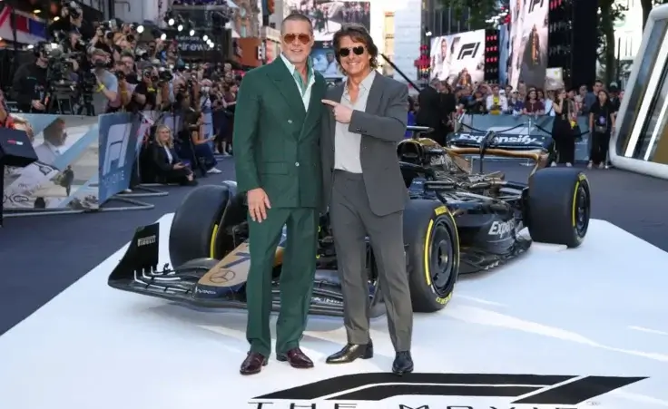 Brad Pitt, left, and Tom Cruise pose for photographers upon arrival at the premiere of the film 'F1 The Movie' on Monday, June 23, 2025, in London. (Photo by Scott A Garfitt/Invision/AP)