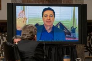 FILE - Former FBI director James Comey is sworn via videoconference before testifying during a Senate Judiciary Committee hearing on Capitol Hill in Washington, Wednesday, Sept. 30, 2020, to examine the FBI "Crossfire Hurricane" investigation. (Ken Cedeno/Pool via AP, File)