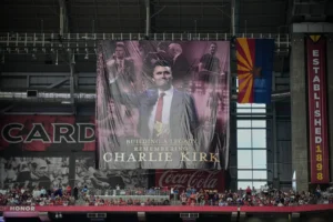 A banner for conservative activist Charlie Kirk is seen during a memorial service for Kirk, Sunday, Sept. 21, 2025, at State Farm Stadium in Glendale, Ariz. (AP Photo/John Locher)