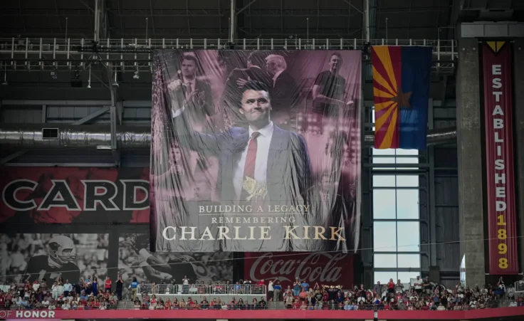 A banner for conservative activist Charlie Kirk is seen during a memorial service for Kirk, Sunday, Sept. 21, 2025, at State Farm Stadium in Glendale, Ariz. (AP Photo/John Locher)