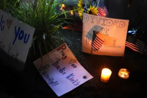 Signs are seen at a growing vigil for Charlie Kirk outside Timpanogos Regional Hospital after Kirk was shot and killed Wednesday, Sept. 10, 2025, in Orem, Utah. (AP Photo/Lindsey Wasson)