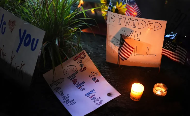 Signs are seen at a growing vigil for Charlie Kirk outside Timpanogos Regional Hospital after Kirk was shot and killed Wednesday, Sept. 10, 2025, in Orem, Utah. (AP Photo/Lindsey Wasson)