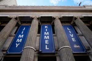 Banners are placed outside the El Capitan Entertainment Centre, where Jimmy Kimmel Live! is filmed, on Thursday, Sept. 18, 2025, in Los Angeles. (AP Photo/Damian Dovarganes)