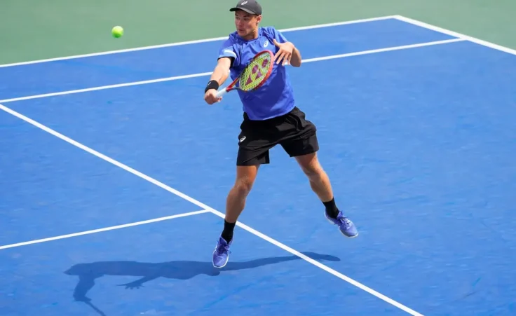 Kamil Majchrzak, of Poland, returns a shot to Karen Khachanov, of Russia, during the second round of the U.S. Open tennis championships, Thursday, Aug. 28, 2025, in New York. (AP Photo/Kirsty Wigglesworth)