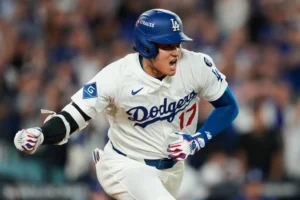 Los Angeles Dodgers' Shohei Ohtani reacts as he drives in a run with a single during the sixth inning in Game 2 of the National League Wild Card baseball playoff series against the Cincinnati Reds, Wednesday, Oct. 1, 2025, in Los Angeles. (AP Photo/Mark J. Terrill)