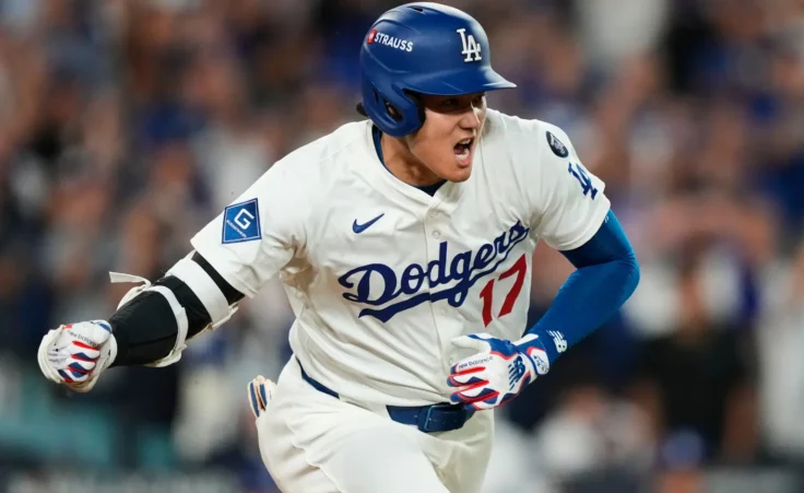 Los Angeles Dodgers' Shohei Ohtani reacts as he drives in a run with a single during the sixth inning in Game 2 of the National League Wild Card baseball playoff series against the Cincinnati Reds, Wednesday, Oct. 1, 2025, in Los Angeles. (AP Photo/Mark J. Terrill)
