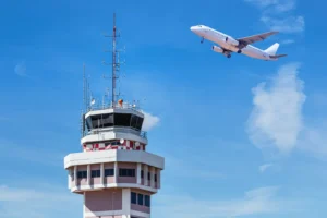 Unspecified air traffic control tower with jet airplane taking off. By Soonthorn/stock.adobe.com. Unstaffed government shutdown
