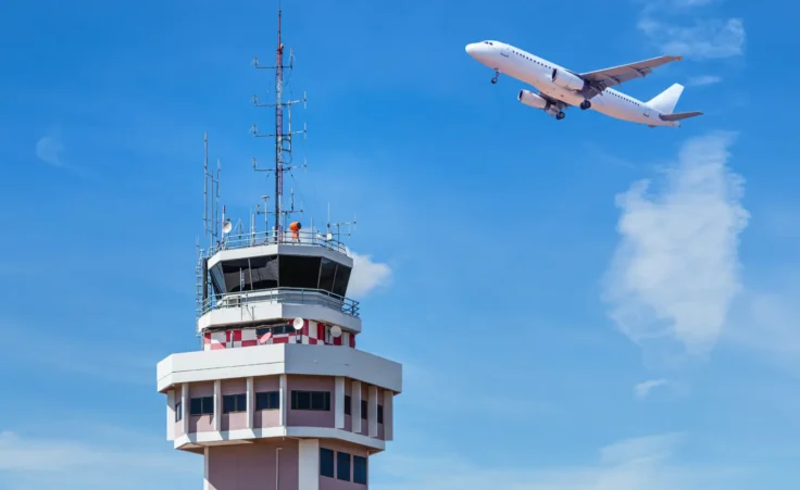 Unspecified air traffic control tower with jet airplane taking off. By Soonthorn/stock.adobe.com. Unstaffed government shutdown