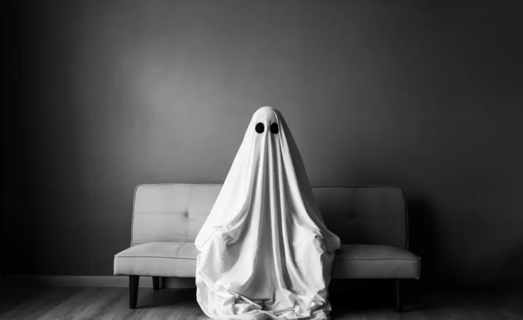 Ghost covered with a white ghost sheet on a sofa in a hotel. By AndriiLysenko/stock.adobe.com. Visiting “haunted” hotels and explaining the paranormal