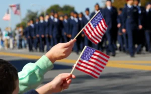 Flag waving at Veteran's Day Parade. By Cheryl Casey/stock.adobe.com