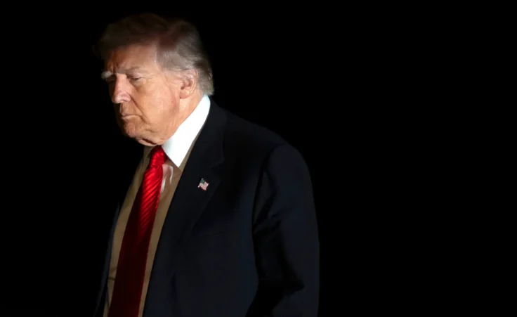 President Donald Trump is illuminated by a camera flash as he walks across the South Lawn of the White House, Sunday, Nov. 2, 2025, in Washington, after returning from a trip to Florida. (AP Photo/Mark Schiefelbein) heaven