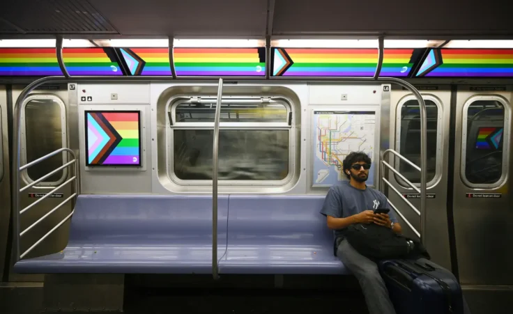 A commuter sits in a downtown subway car as digital advertising panels display messages of Pride Month celebration, New York, NY, June 26, 2025. As New York City prepares to celebrate Pride Month with an annual parade on Sunday, the nation is marking a decade since the Supreme Court's historic Obergefell v. Hodges decision legalized same-sex marriage nationwide. (Photo by Anthony Behar/Sipa USA)(Sipa via AP Images)