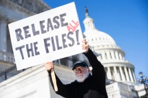 Bill Christeson holds a sign referencing the Jeffrey Epstein files outside the U.S. Capitol on Wednesday, November 12, 2025. (Tom Williams/CQ Roll Call via AP Images)