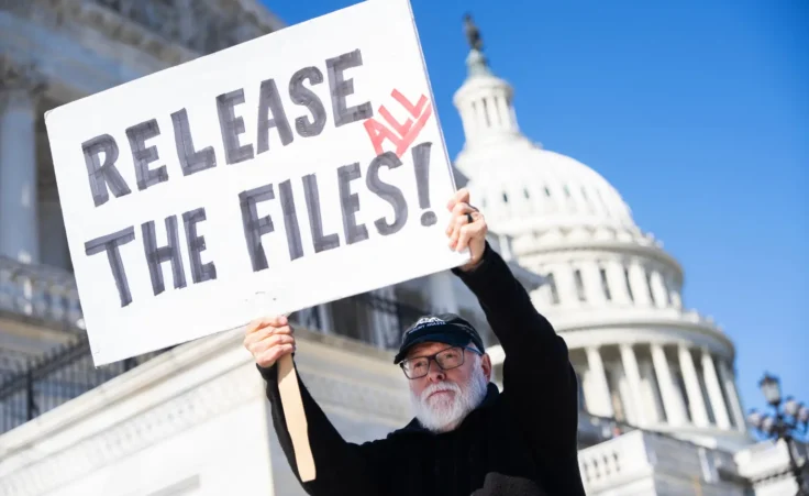 Bill Christeson holds a sign referencing the Jeffrey Epstein files outside the U.S. Capitol on Wednesday, November 12, 2025. (Tom Williams/CQ Roll Call via AP Images)