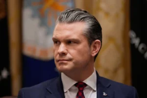 Defense Secretary Pete Hegseth listens as President Donald Trump speaks during a Cabinet meeting at the White House, Tuesday, Dec. 2, 2025, in Washington. (AP Photo/Julia Demaree Nikhinson)