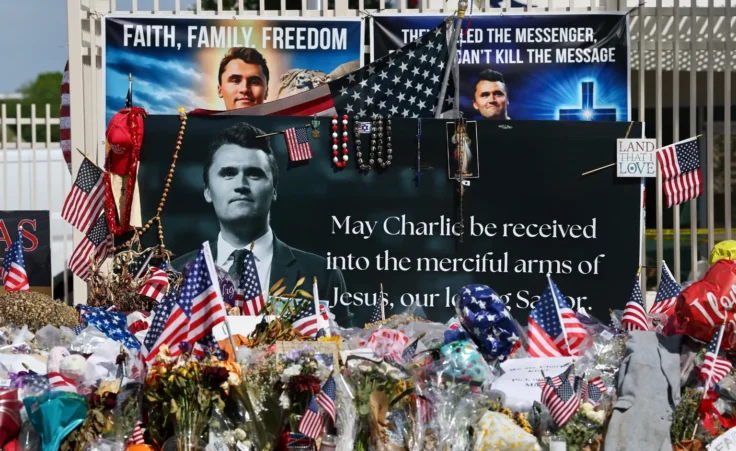 Flowers, candles, American Flags and other items fill a makeshift memorial for Charlie Kirk outside the Turning Point USA headquarters, Thursday, Sept. 25, 2025, in Phoenix. (Aaron M. Sprecher via AP)