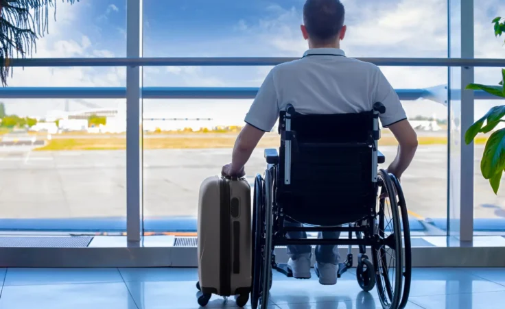 Young man in a wheelchair at the airport. By manaemedia/stock.adobe.com.