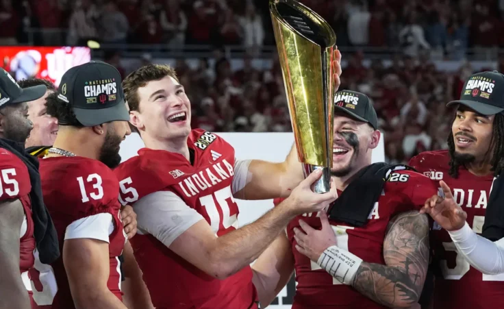 Indiana quarterback Fernando Mendoza holds the trophy after their win against Miami in the College Football Playoff national championship game, Monday, Jan. 19, 2026, in Miami Gardens, Fla. (AP Photo/Marta Lavandier)