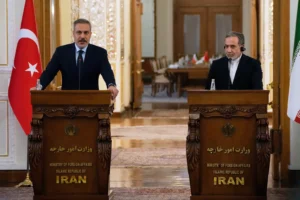 Turkish Foreign Minister Hakan Fidan, left, speaks in a joint news briefing with his Iranian counterpart Abbas Araghchi after their meeting, in Tehran, Iran, Sunday, Nov. 30, 2025. (AP Photo/Vahid Salemi) Will the US bomb Iran?
