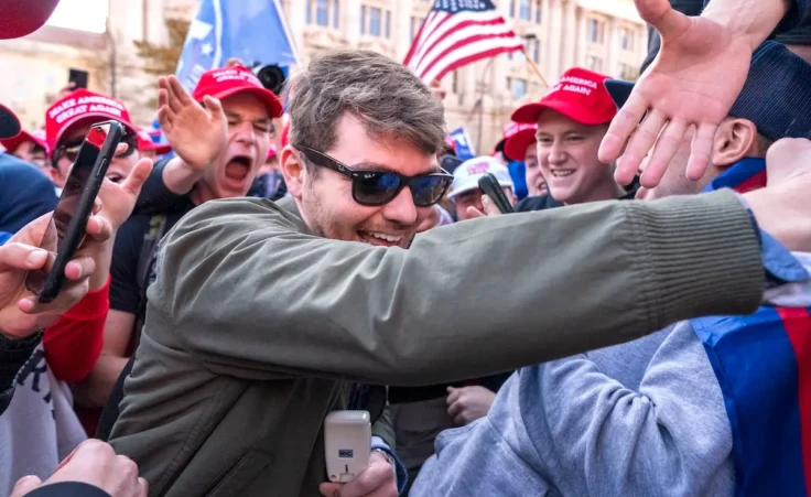 FILE- Nick Fuentes right-wing podcaster, center, greets supporters before speaking at a pro-Trump march, Nov. 14, 2020, in Washington. Former President Donald Trump had dinner Tuesday, Nov. 22, 2022, at his Mar-a-Lago club with the rapper formerly known as Kanye West, who is now known as Ye, as well as Nick Fuentes, who has used his online platform to spew antisemitic and white supremacist rhetoric. (AP Photo/Jacquelyn Martin, File)