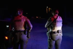 Sheriff's officials block the entrance to a road where a home was being searched in Rio Rico, Arizona, on Tuesday, Feb. 10, 2026, in connection to the investigation of Nancy Guthrie's disappearance. (AP Photo/Ty ONeil)