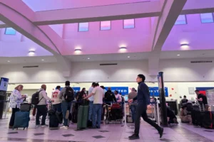 People stand in line at check-in counters at El Paso International Airport, Wednesday, Feb. 11, 2026, in El Paso, Texas. (AP Photo/Morgan Lee) government airport shutdown